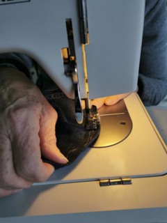 Hands of woman with a sewing machine