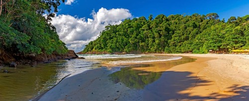 Panoramic image of Ribeira beach surrounded by rainforest and with the river flowing into the sea in Itacare on the south coast of Bahia
