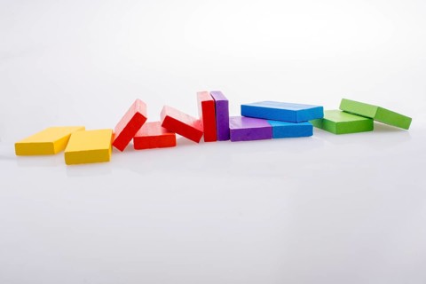 Colorful Domino Blocks in a line on a white background