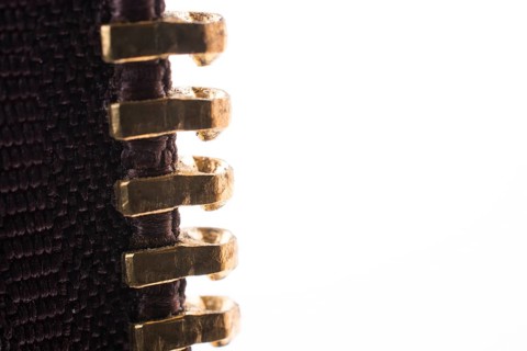 Close up or macro of a brown zipper on white background