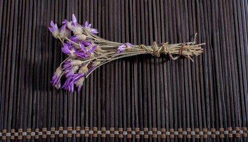 Bunch of flowers are placed on a straw mat