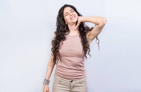Young stressed woman with neck pain isolated. Tired girl with neck pain isolated. Stress and neck pain concept