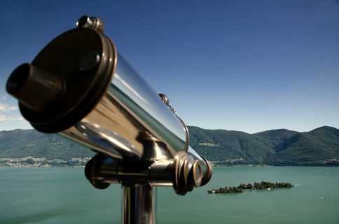 Telescope and Mountain over Alpine Lake Maggiore with Clear Sky in Brissago Islands in Ticino