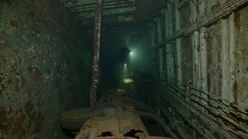 Scuba diver swim above car lying inside cramped hold of ferry Salem Express shipwreck