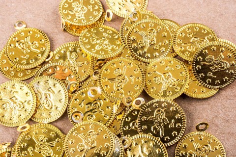 Spiral notebook and the gold coins on white background