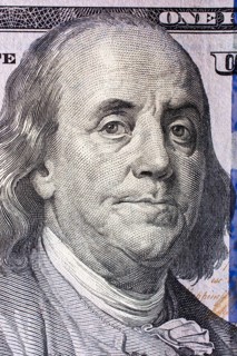 Close up of Benjamin Franklin face on 100 US dollar bill
