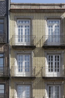 House facade tiled with azulejos and with iron balconies