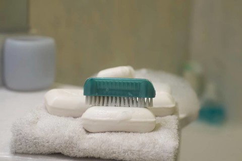 Soap and brush nail cleaner in bathroom