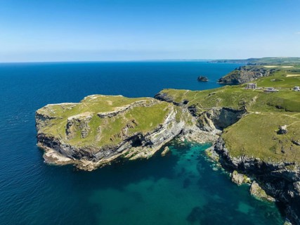 Aerial view of the rugged coastline on the Celtic Sea with the Tintagel Peninsula and the ruins of Tintagel Castle