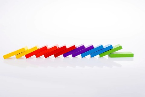 Colorful Domino Blocks in a line on a white background