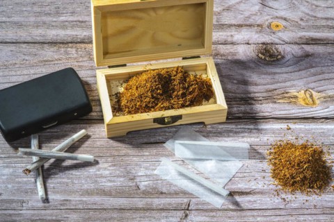 Wooden box with rolling tobacco