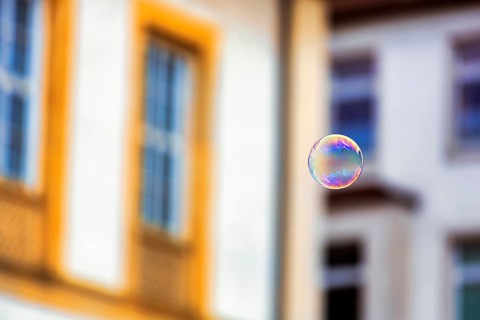 Single soap bubble floating in the city centre