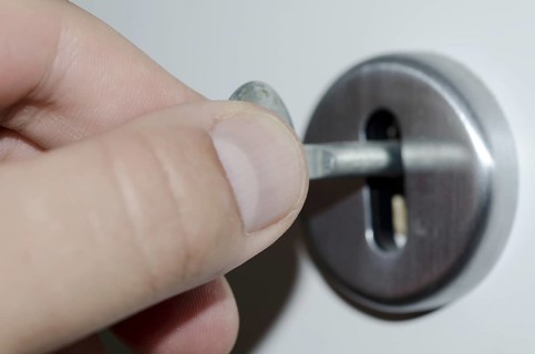Hand Turns the Key in the Lock