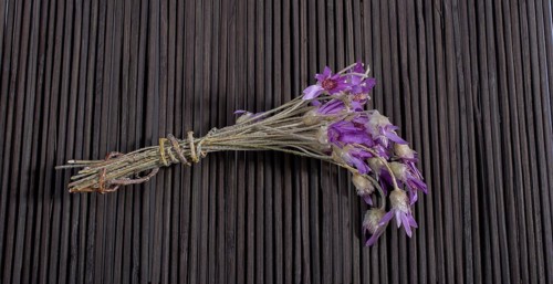 Bunch of flowers are placed on a straw mat