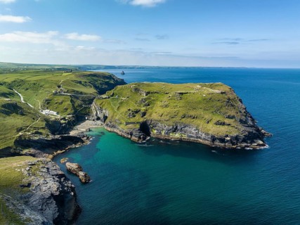 Aerial view of the rugged coastline on the Celtic Sea with the Tintagel Peninsula and the ruins of Tintagel Castle