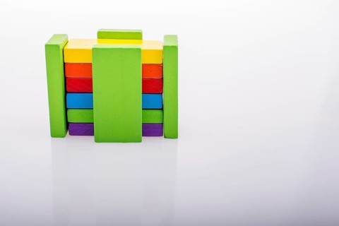 Colorful Domino Blocks in a line on a white background