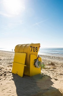 Yellow beach chair and mudflats