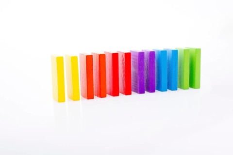 Colorful Domino Blocks in a line on a white background