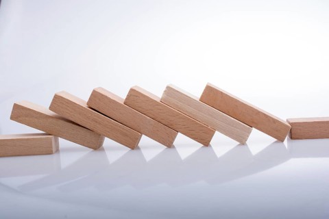 Wooden Domino Blocks in a line on a white background