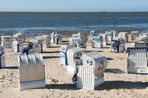 White beach chairs and mudflats
