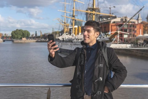 Happy tourist taking a selgie in Puerto Madero