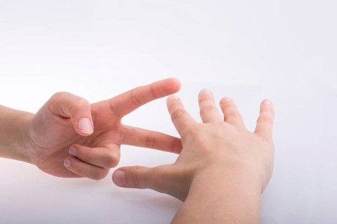 Hands showing the symbols rock paper scissors