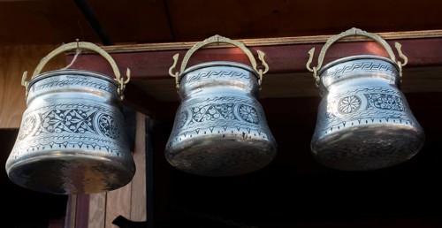 Little set of buckets of made of metal in a market place