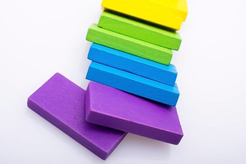 Colorful Domino Blocks in a line on a white background