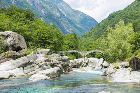 River in Valley Verzasca and Bridge Ponte dei Salti with Mountain in a Sunny Day in Ticino
