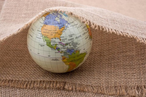 Model globe placed under a linen canvas