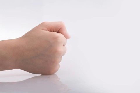 Clenched fist hand on a white background