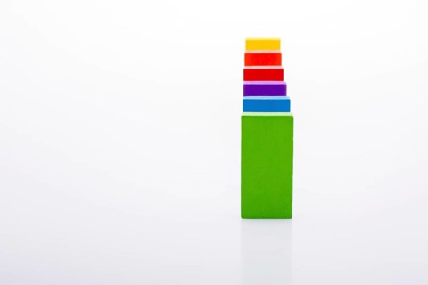 Colorful Domino Blocks in a line on a white background