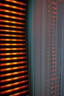 Illuminated Orange Stripes on a Modern Column in Switzerland
