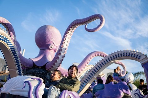 Couple of latin friends having fun in an amusement park