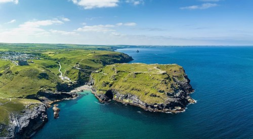 Aerial panorama of the rugged coastline on the Celtic Sea with the Tintagel Peninsula and the ruins of Tintagel Castle