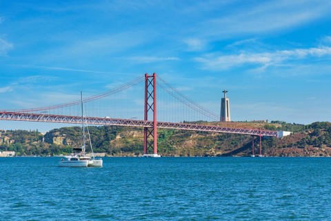View of 25 de Abril Bridge famous tourist landmark over Tagus river