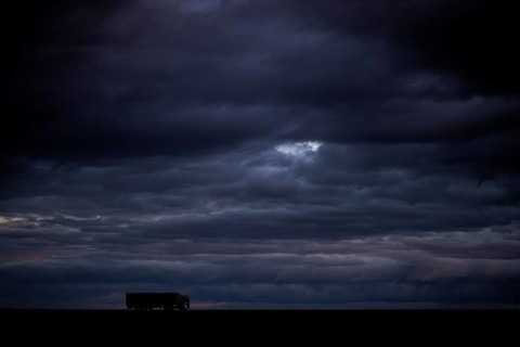 A lorry stands out on a country road at blue hour in Vierkirchen
