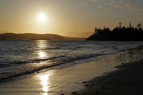 Deserted sandy beach at sunset