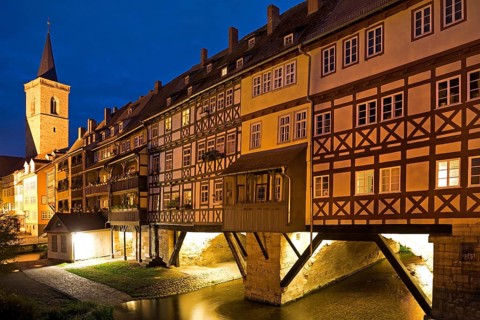 Half-timbered houses of the Kraemerbruecke with the river Gera and the Aegidienkirche in the evening
