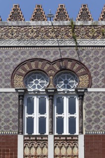 Ceramic tile facade with horseshoe window