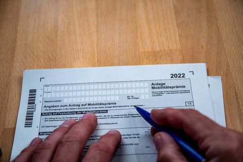 Male hand with biros in front of income tax declaration form