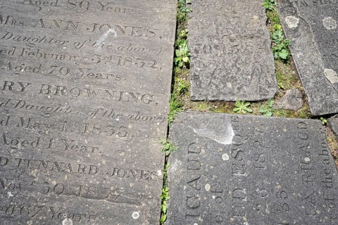 Old gravestones with inscriptions are used as stepping stones