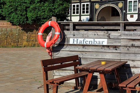 Wooden seating group on terrace of a bar