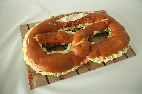 Large pretzel with cheese and sausage