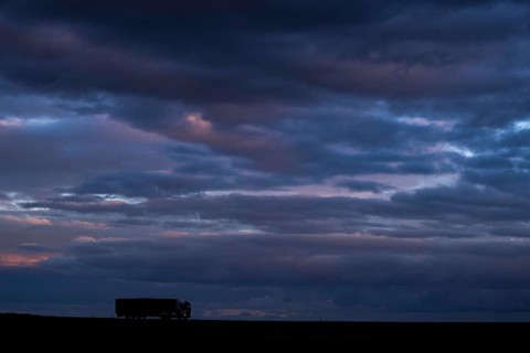 A lorry stands out on a country road at blue hour in Vierkirchen