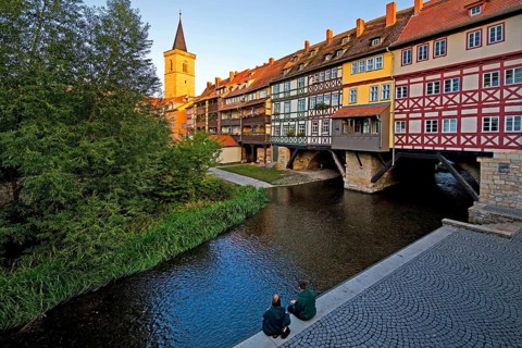 Half-timbered houses of the Kraemerbruecke with the river Gera and the Aegidienkirche