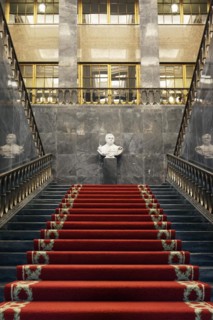 Pompous black marble staircase with red carpet