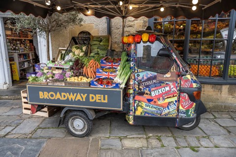 A Piaggio Ape tricycle as a vegetable stall on the high street of Broadway