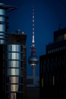 The TV tower looms behind office buildings in Berlin