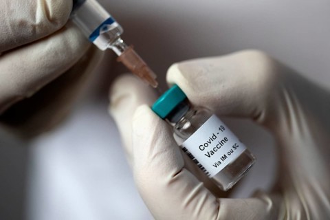 Covid 19 vaccine. Drawing up a vaccine dose.